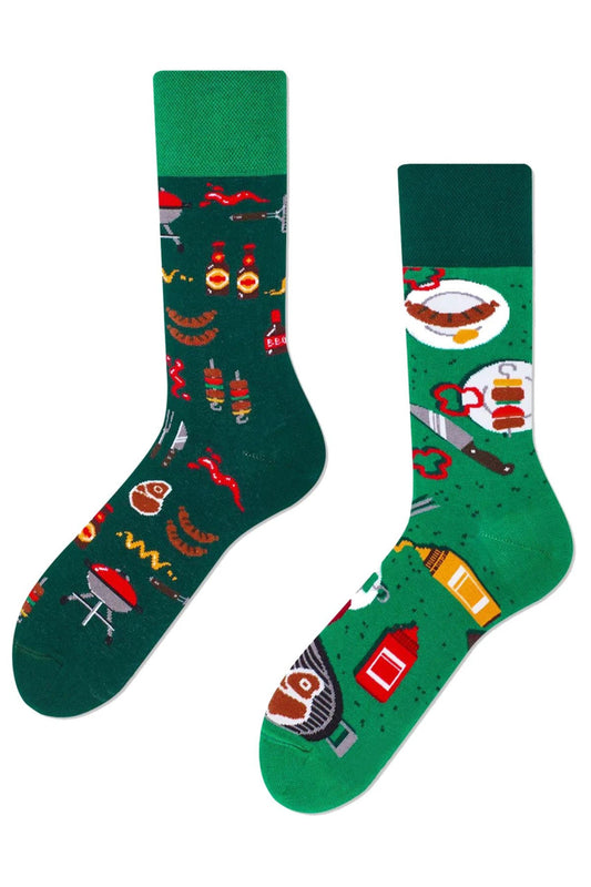 Unisex mismatched green socks with barbecue food and grill tools design.