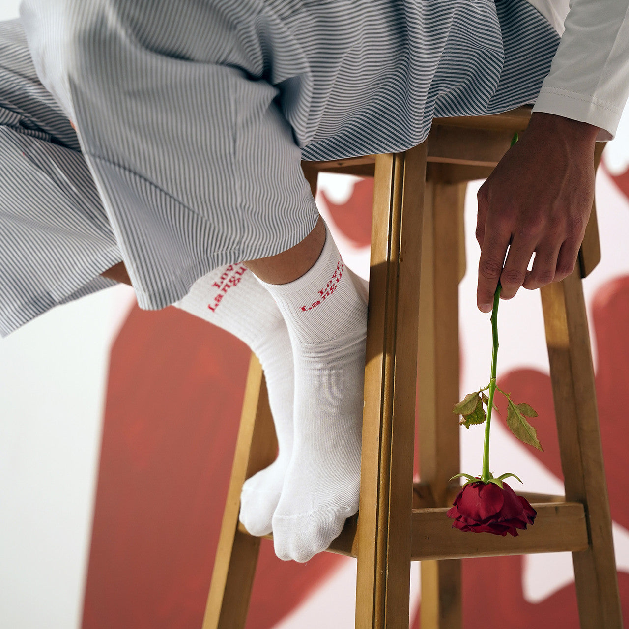 White sporty socks with “Love Language” printed in bold red, a collaboration between Socksat and Amar Attire.