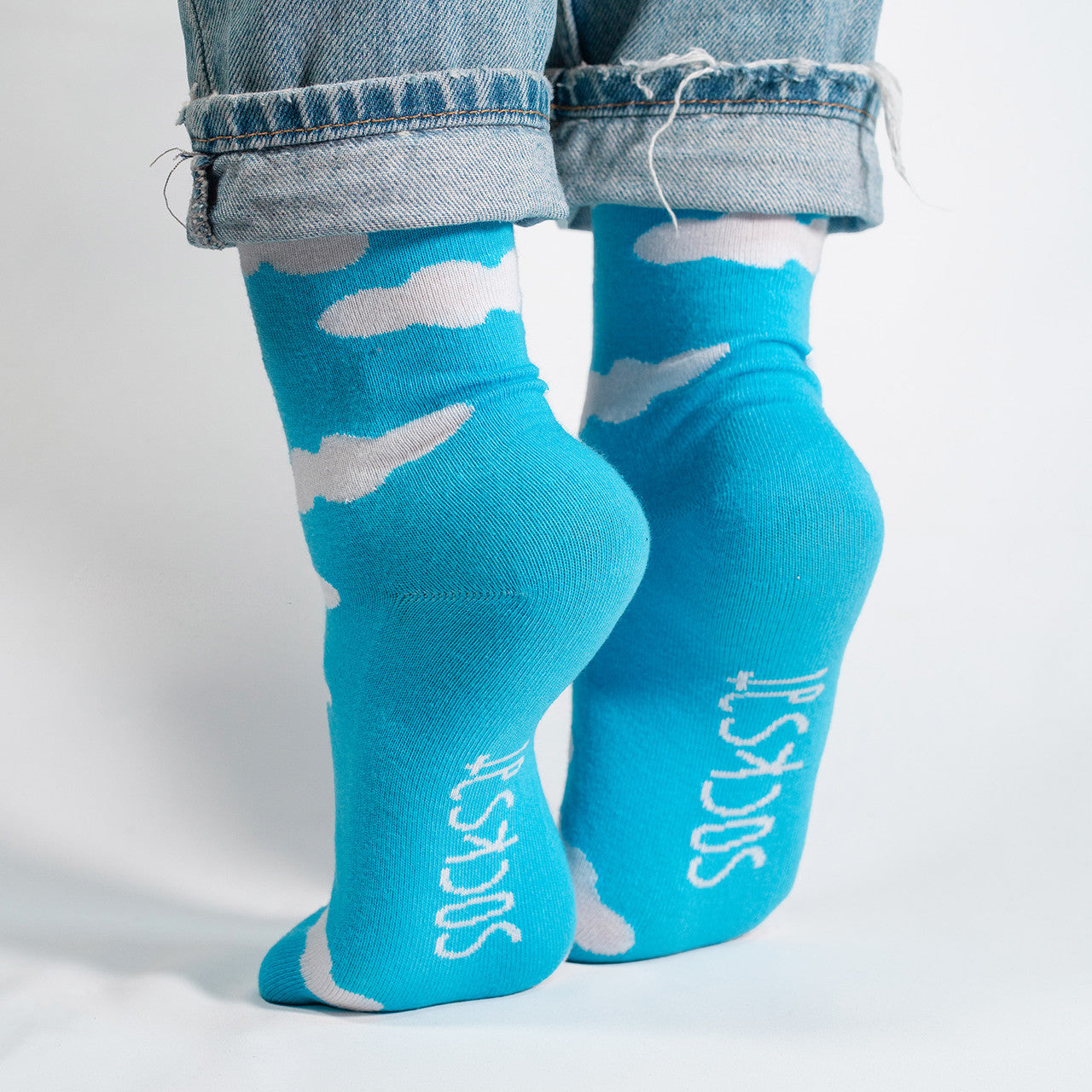 Float into the serene beauty of the sky with our White Clouds on Sky Blue Socks. These socks feature a dreamy pattern of fluffy white clouds against a calming sky blue backdrop, creating a tranquil and picturesque design.
Crafted for comfort and style, these socks are a breath of fresh air for your wardrobe. Whether you're strolling through the city or daydreaming in the countryside, our White Clouds on Sky Blue Socks are the perfect companion for an added touch of whimsy.
Step into the tranquility of the