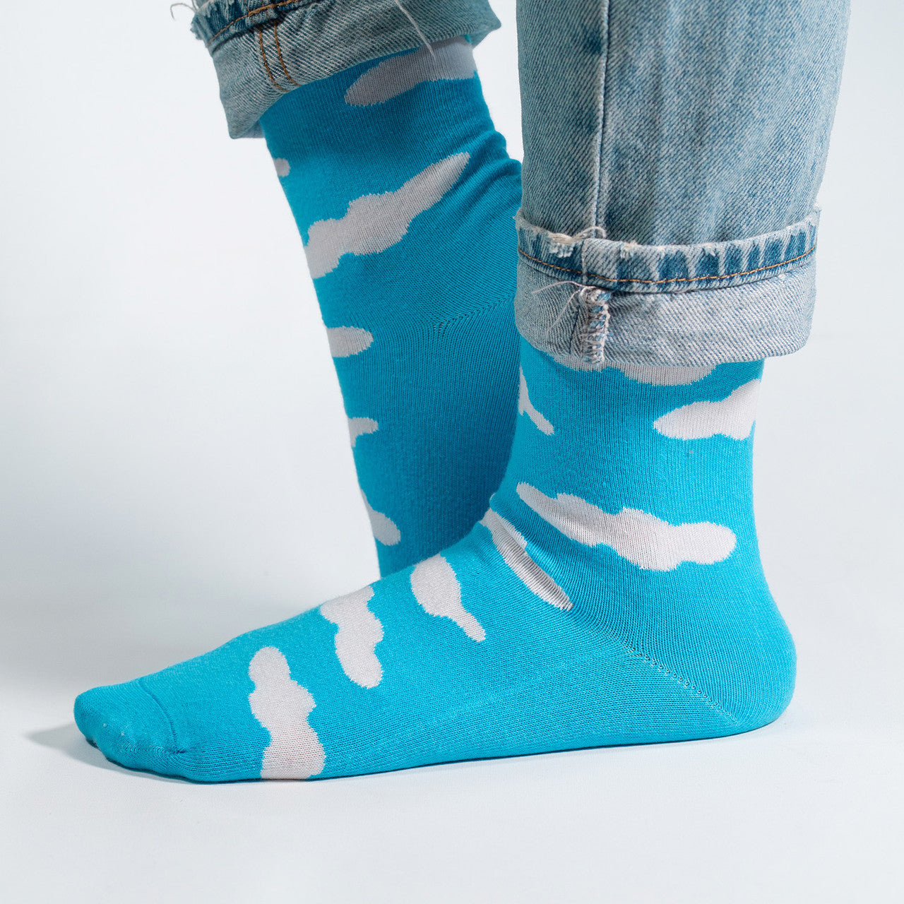 Float into the serene beauty of the sky with our White Clouds on Sky Blue Socks. These socks feature a dreamy pattern of fluffy white clouds against a calming sky blue backdrop, creating a tranquil and picturesque design.
Crafted for comfort and style, these socks are a breath of fresh air for your wardrobe. Whether you're strolling through the city or daydreaming in the countryside, our White Clouds on Sky Blue Socks are the perfect companion for an added touch of whimsy.
Step into the tranquility of the