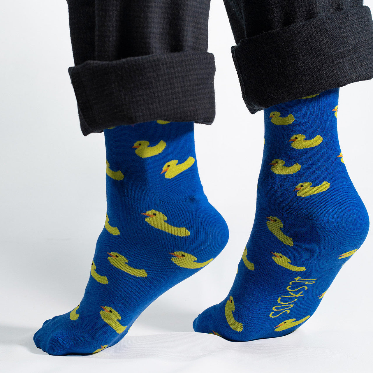 Introducing our whimsical Yellow Ducks on Blue Socks – the perfect blend of comfort and playfulness for your sock collection. Against a vibrant blue background, these socks feature adorable yellow rubber ducks, creating a charming and cheerful design.
Crafted for comfort and durability, our Yellow Ducks on Blue Socks bring a touch of nostalgia and fun to your everyday style. Whether you're a rubber duck enthusiast or simply looking for a quirky addition to your wardrobe, these socks are sure to make a spla