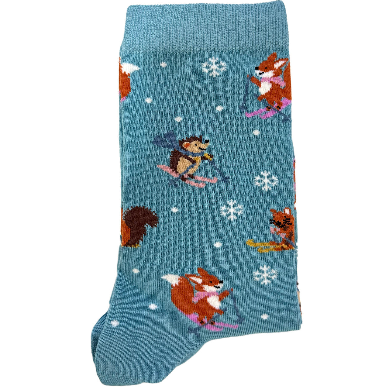 Green women’s socks featuring forest animals—hedgehog, fox, and squirrel—skiing in a snowy festive design.