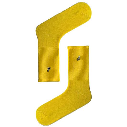 Yellow athletic socks with a banana icon, fun and breathable sport socks.