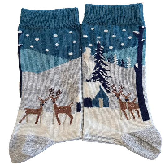 Winter-themed socks with deer, snowy forest background, trees, and a cozy wooden hut.