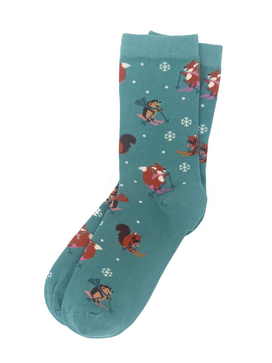 Green women’s socks featuring forest animals—hedgehog, fox, and squirrel—skiing in a snowy festive design.