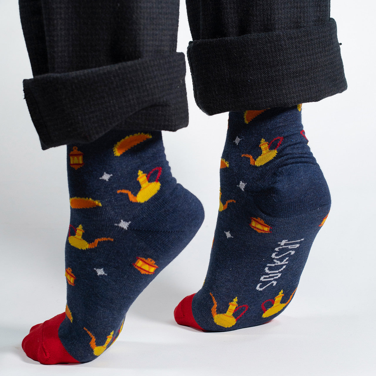 Elevate your Ramadan celebrations with our exclusive Ramadan Treats Socks. Against a rich navy background, these socks feature enchanting Ramadan fanous lanterns and atayef, creating a festive and stylish design that captures the spirit of the season.

Crafted with comfort in mind, these socks are the perfect addition to your Ramadan wardrobe. Whether you're attending iftar gatherings or celebrating with family, our Ramadan Treats Socks add a touch of warmth and style to your ensemble.

Celebrate the joy of