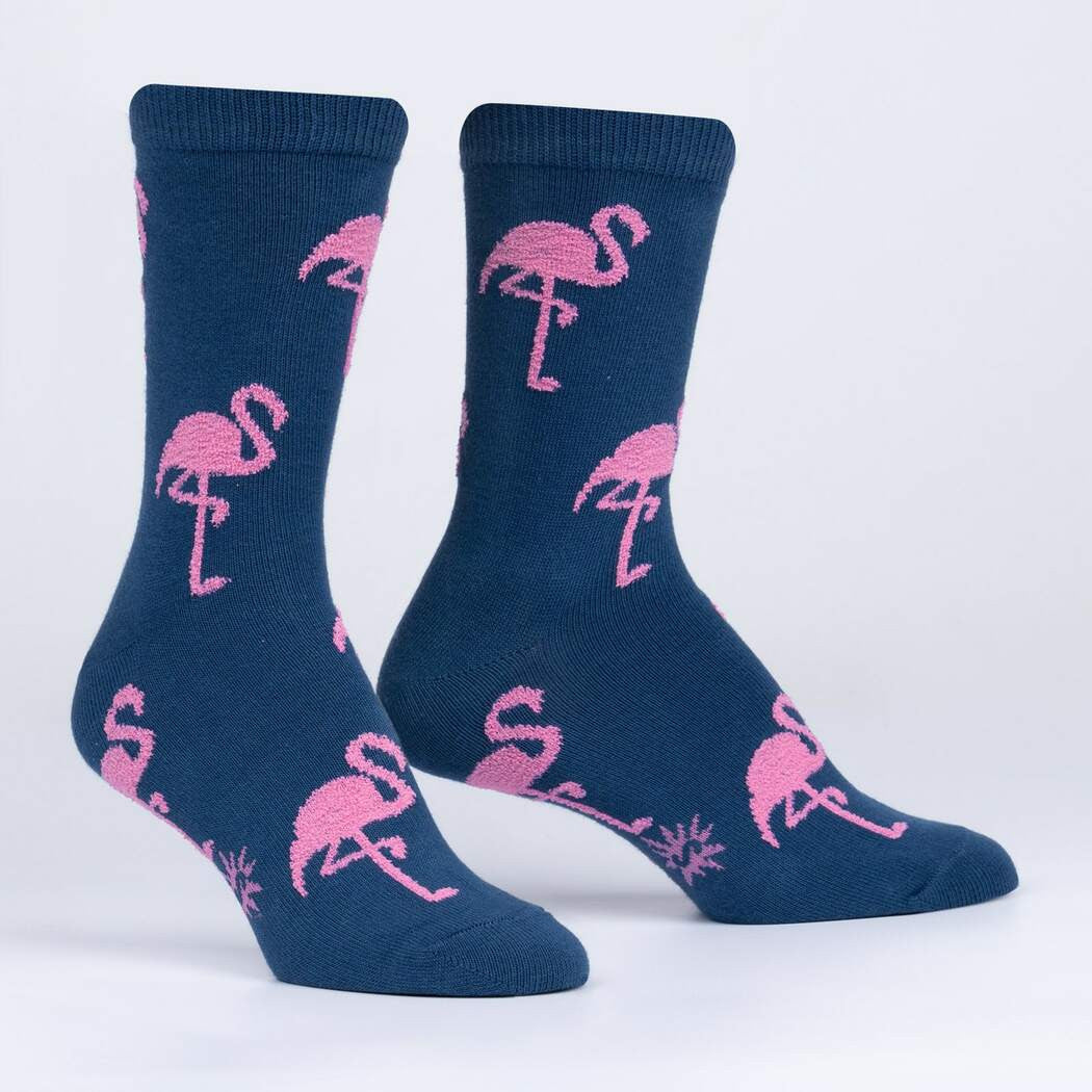 Did you know flamingos aren't born pink? They're born with whitish feathers, and turn pink from the algae and crustaceans they eat. It's hard to say definitively why they stand on one foot, but that pose and their famous coloring make them instantly recognizable creatures. We had to illustrate them for ourselves, and make a sock that'll flamin-go with you anywhere you like.