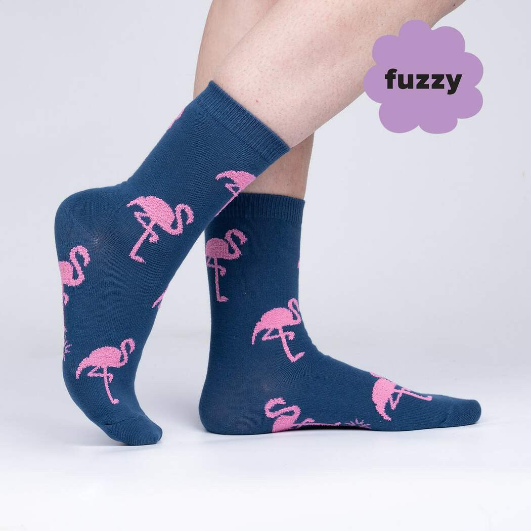 Did you know flamingos aren't born pink? They're born with whitish feathers, and turn pink from the algae and crustaceans they eat. It's hard to say definitively why they stand on one foot, but that pose and their famous coloring make them instantly recognizable creatures. We had to illustrate them for ourselves, and make a sock that'll flamin-go with you anywhere you like.