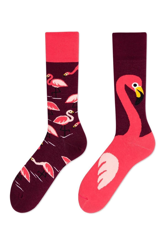 Mismatched flamingo socks with vibrant tropical designs, fun and colorful style.
