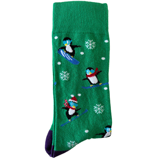 Men’s green socks featuring snowboarding penguins wearing Christmas hats and scarves in a festive design.